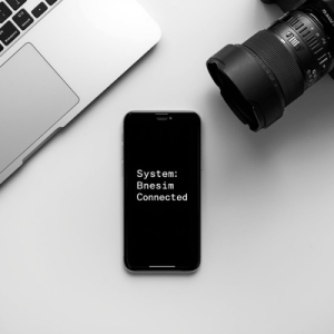 Tech-focused workspace with a smartphone displaying Bnesim network status