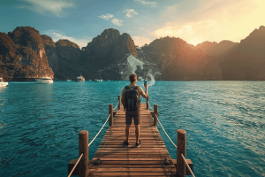Traveler using a smartphone with a digital eSIM network overlay at Maya Bay, Phuket, Thailand